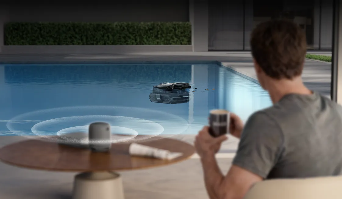 Beatbot AquaSense X AI robotic pool cleaner controlled by voice assistant near the pool.